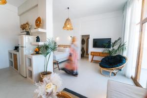 a person is walking through a living room at Divino Caldera in Akrotiri