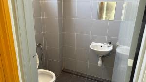 a bathroom with a sink and a toilet at Summer Hotel Kampar Perak in Kampar +13 photos