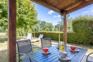 a blue table and chairs on a patio at Maison de 2 personnes in Maillé