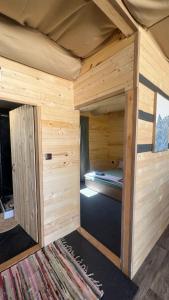 a large wooden cabin with a bed in it at Бунгало woodwave in Chernomorets +23 photos