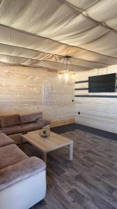 a living room with a couch and a table at Бунгало woodwave in Chernomorets