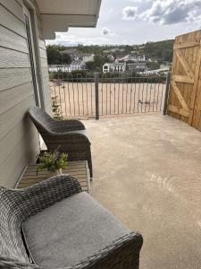two wicker chairs sitting on a porch with a fence at Cwtch Glanmordy by Aberporth Beach Holidays in Aberporth +14 photos