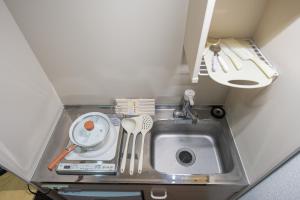 a kitchen counter with a sink and utensils at 四季安々 in Tokyo +15 photos