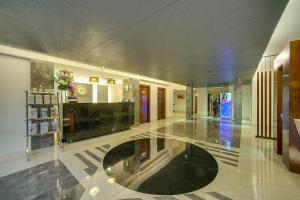 a lobby of a building with a glass floor at Muse Sarovar Portico Nehru Place in New Delhi