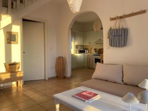 a living room with a couch and a table at Villa Blue in Agios Georgios