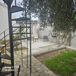 a spiral staircase leading to a patio with chairs at House near beach in Peñíscola for 4 in Peñíscola