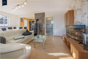 a living room with a large flat screen tv at Ferienhaus Ulme in Kachlin
