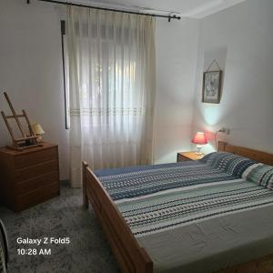 a bedroom with a large bed and a window at House near beach in Peñíscola for 4 in Peñíscola +12 photos