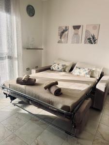 a bed in a bedroom with two pillows on it at Cagliari AirPort Apartment in Elmas +8 photos