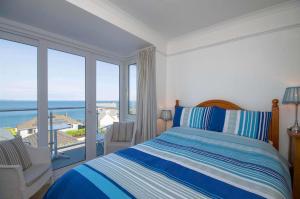 a bedroom with a bed and a view of the ocean at Seaview in Looe