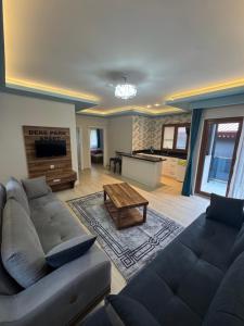 a living room with a couch and a table at Derepark Apart in Uzungol