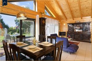 a dining room with a table and chairs at Ferienhaus Villa Riesling in Zempin