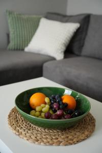 a green bowl of fruit on a table at Forrest Hotel in Skhidnitsa