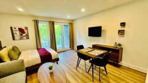 a room with a bed and a table with a couch at Swimming Pool Spa - Condo Mont Tremblant 2 in Mont-Tremblant