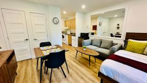a bedroom with a bed and a living room with a table at Swimming Pool Spa - Condo Mont Tremblant 2 in Mont-Tremblant