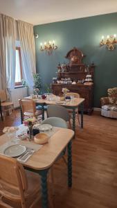 a dining room with tables and chairs and a piano at Dimora Storica Nella Torre Bed & Breakfast in Ascoli Piceno