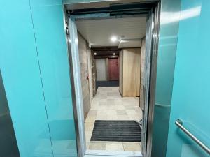 a corridor of an office building with a hallway at Chambres côté mer du bouquet in Cosqueville