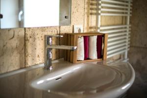 a bathroom sink with a soap dispenser on top of it at Enoturismo Le Rampe in Vittorio Veneto