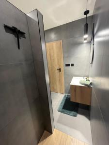 a bathroom with a sink and a shower at LEMAR APART Tatry F205 in Veľká Lomnica
