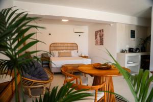 a bedroom with a bed and a table and chairs at Divino Caldera in Akrotiri