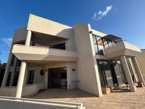 a large white house with a balcony on top of it at Comfort Home For You豪华双人间2 in Perth