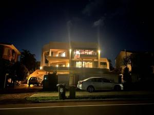 a white car parked in front of a house at night at Comfort Home For You豪华双人间2 in Perth +5 photos