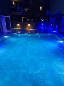 a large swimming pool at night with blue lights at Premium Studio Family I in Paralia Katerinis
