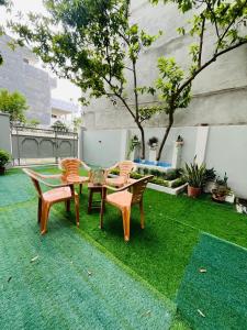 a patio with a table and chairs on the grass at THS Home Stay in Varanasi