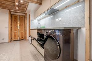 a washer and dryer in a large kitchen at Silbersberg Cottage in Gloggnitz