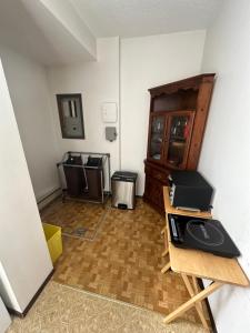 a room with a room with a table and a microwave at Beautiful home near City centre! in Kitimat