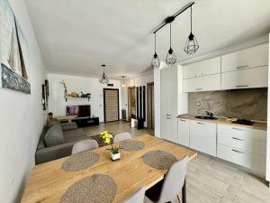 a kitchen and living room with a table and chairs at Allezzi Resort Mamaia Nord D 13 in Mamaia