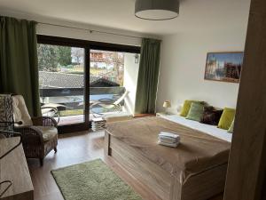 a bedroom with a large bed and a large window at Bergfeuer in Garmisch-Partenkirchen