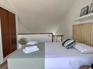 a bedroom with a bed with two towels on it at Apartaments Aeroclub in Empuriabrava