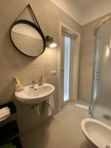 a bathroom with a sink and a mirror and a shower at Elevada in Castellammare di Stabia +24 photos