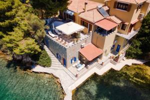 an aerial view of a house with a swimming pool at Porto Castello Villas in Skiathos +33 photos