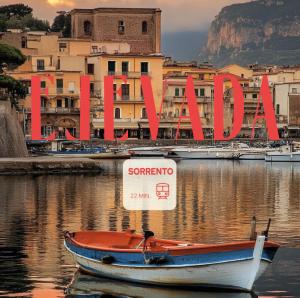 a small boat in the water in front of a city at Elevada in Castellammare di Stabia