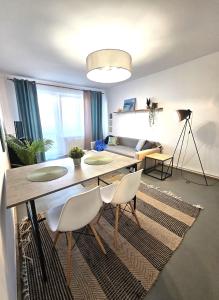 a living room with a dining room table and chairs at Tabago Studio 36 Brzeg Chopina in Brzeg +3 photos