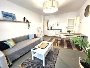 a living room with a couch and a table at Tabago Studio 36 Brzeg Chopina in Brzeg