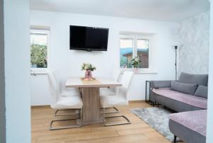 a living room with a table and a couch at New Istrian Experience by Istrian apartments Koper in Koper
