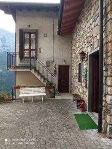 a building with a bench and a staircase on it at Cà LENZI in Colere