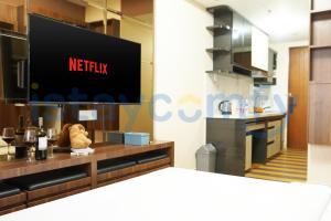 a television on a wall in a room at Studio Pollux Habibie A1003 City and Sea View in Batam Center