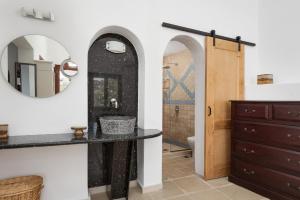 a bathroom with a sink and a mirror at Porto Castello Villas in Skiathos Town +33 photos