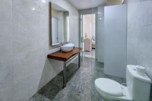 a bathroom with a sink and a toilet at Emilia 1 Bedroom Apartment Seminyak by Nagisa Bali in Kerobokan +6 photos