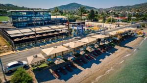 an overhead view of a beach with umbrellas and chairs at Sea View Serenity Βeachfront & Pool 105 in Salamís