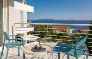 a balcony with chairs and a table and a view of the ocean at VILLA MON AMOUR by Villas Guide in Blato