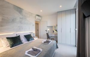a bedroom with a large bed with towels on it at VILLA MON AMOUR by Villas Guide in Blato +28 photos