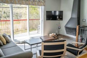 a living room with a couch and a table at Ski Condo - Mont du Midi 56 in Saint-Philémon