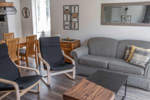 a living room with a couch and chairs and a table at Ski Condo - Mont du Midi 56 in Saint-Philémon