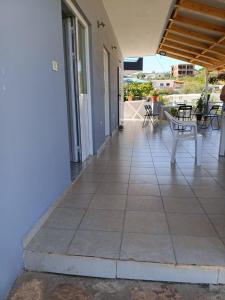 a porch of a house with a table and chairs at Anna! in Ksamil