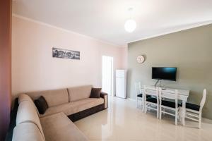 a living room with a couch and a table at Fjori's Apartments in Sarandë